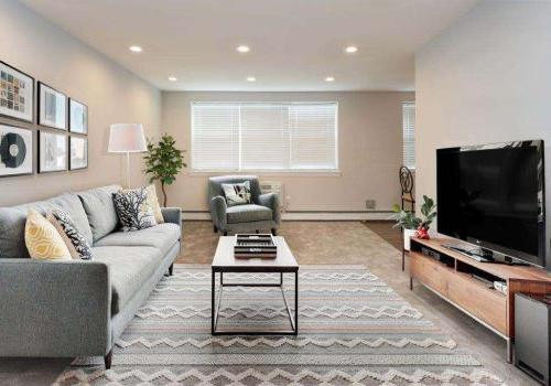 Living room with a couch, chair, and TV at Mt Airy Place apartments for rent in Philadelphia, PA